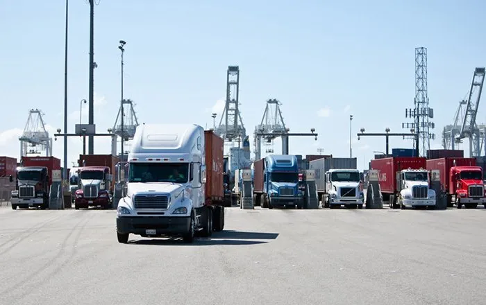 rnd-services-content-home-05-1920w Photo of a white semi truck pulling out of a yard.
